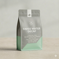 Swiss Water Decaf coffee package on a neutral background